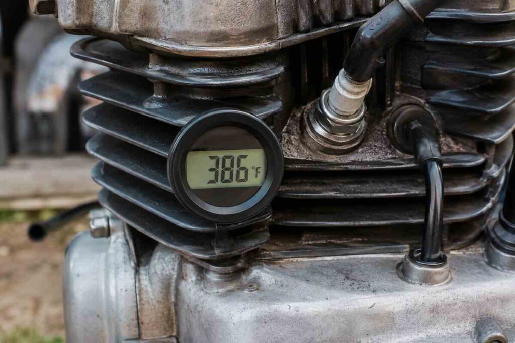Digital cylinder head temperature gauge mounted on an air-cooled motorcycle engine