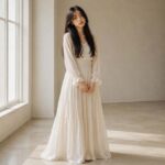Woman with long hair styled in soft wispy curtain bangs long hair framing her face