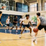 LUSV Basketball players in a defensive drill on court