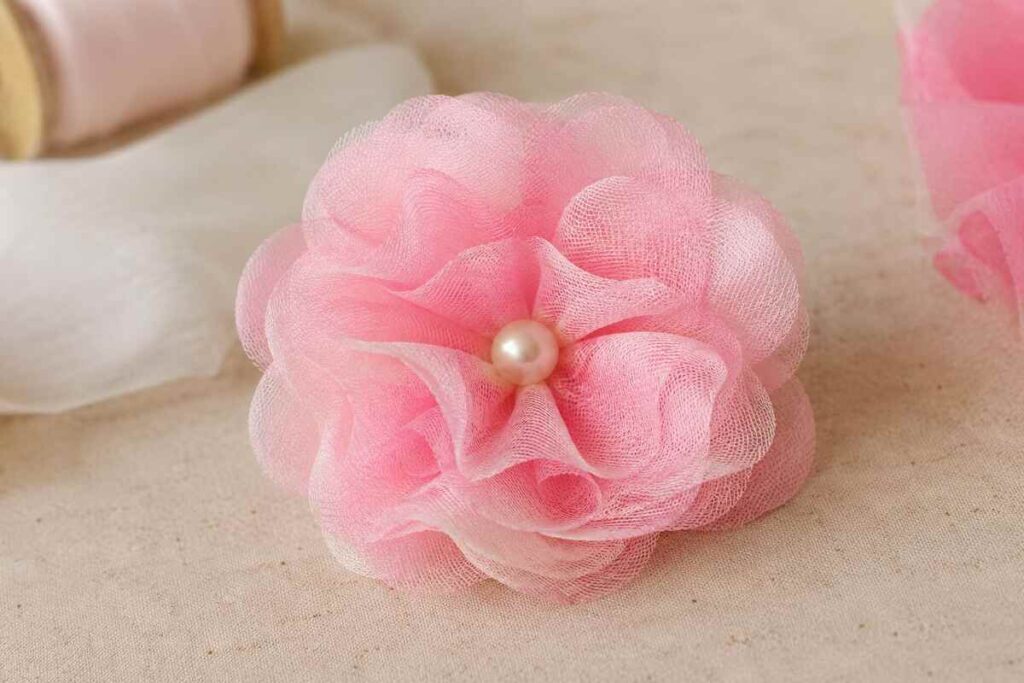 Handmade pink trastullami fabric flower with pearl center