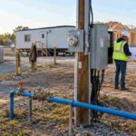 How to set up utilities on a construction site: temporary power pole, water line, and portable toilets