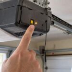 LiftMaster garage door opener learn button with glowing LED on the motor unit
